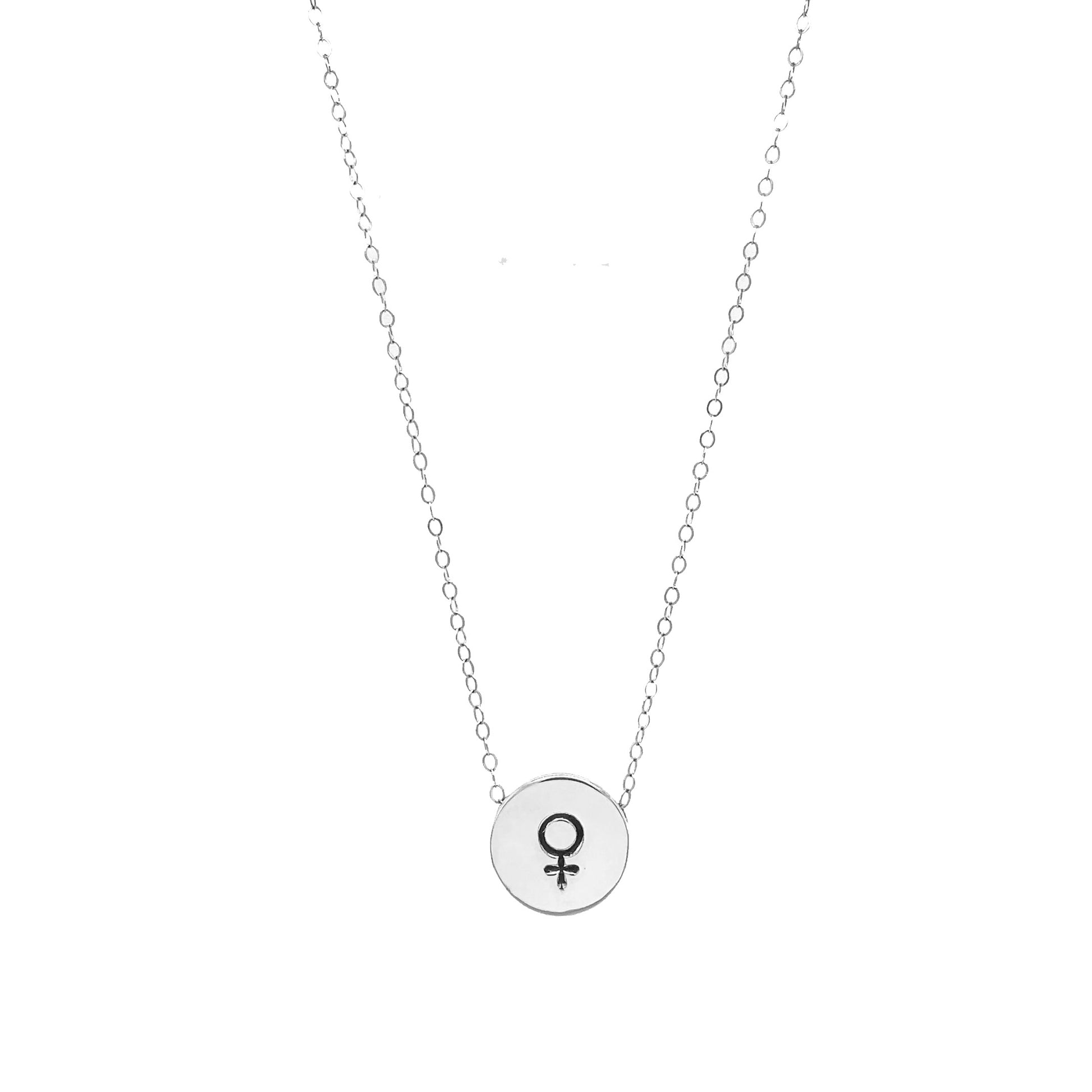 A close-up of our Handmade Venus Symbol Sliding Charm Necklace, featuring a half-inch charm in brass, aluminum, or sterling silver on a 1.5mm cable chain.